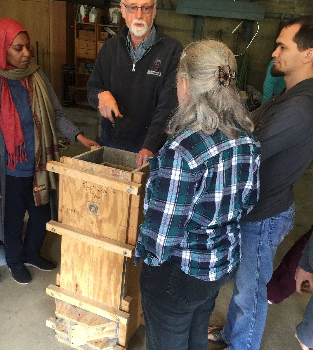 AVFCW Board Member Peter teaches students about an alternative, wooden, water filter mold.